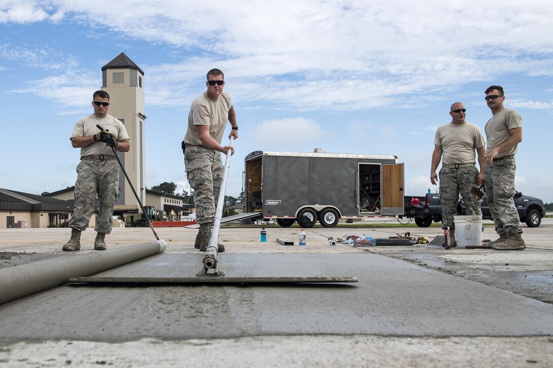 Students use various concrete leveling tools to finish a new patch of cement during a Pavements Maintenance, Inspection and Repair course, June 15, 2017, at Moody Air Force Base, Ga. Every year, training managers at the major command level across the Air Force pick multiple bases across the Air Force to host the course, and this year Moody hosted one from June 5-16. (U.S. Air Force photo by Senior Airman Janiqua P. Robinson)