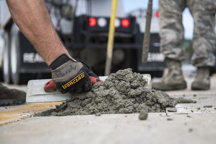 A student uses a leveling tool to finish a new patch of cement during a Pavements Maintenance, Inspection and Repair course, June 15, 2017, at Moody Air Force Base, Ga. Every year, training managers at the major command level across the Air Force pick multiple bases across the Air Force to host the course, and this year Moody hosted one from June 5-16. (U.S. Air Force photo by Senior Airman Janiqua P. Robinson)
