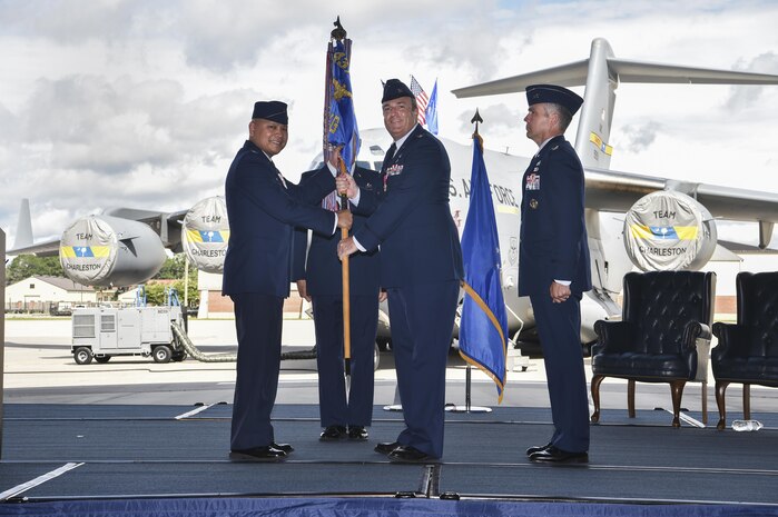 Col. Brian Peters, (right) 437th Maintenance Group outgoing commander, passes the guideon to Col. Jimmy Canlas, (left) 437th Airlift Wing commander, officially relinquishing his position during a change of command ceremony at Joint Base Charleston, S.C., June 9, 2017. Peters assumed command of the 437th MXG in 2014.
