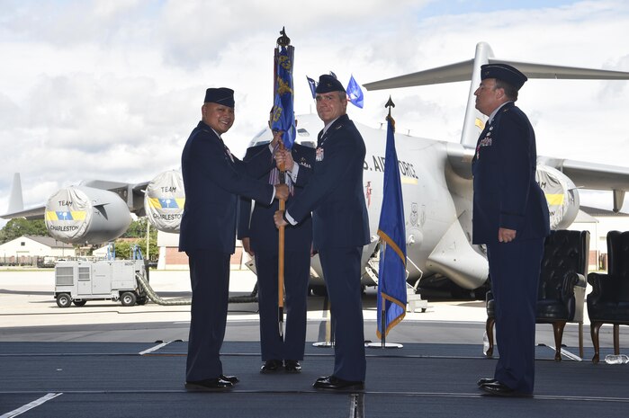 Col. Jimmy Canlas, (left) 437th Airlift Wing commander, passes the guideon to Col. Mark Harris, (right) 437th Maintenance Group incoming commander, signifying the official change of command at Joint Base Charleston, S.C., June 16, 2017. Harris came to Charleston after serving as chief of staff for the deputy chief of staff of Strategic Plans, Programs and Requirements at the Pentagon, Washington, D.C.   