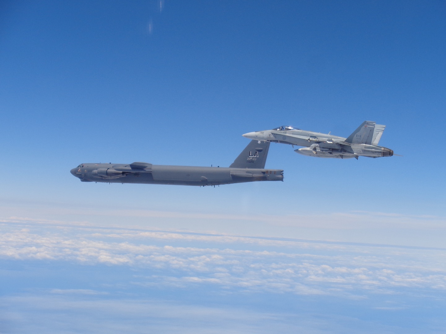 A Canadian NORAD Region CF-18 Hornet practices intercept and escort procedures alongside a United States Air Force (USAF) B-52 Stratofortress bomber during Exercise VIGILANT SHIELD 17-1, June 15-16, 2017.
