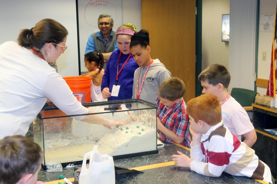 Lisa Winter demonstrates coastal erosion during one of the day's activities during the Take Your Daughters and Sons to Work Day, April 21, 2017.