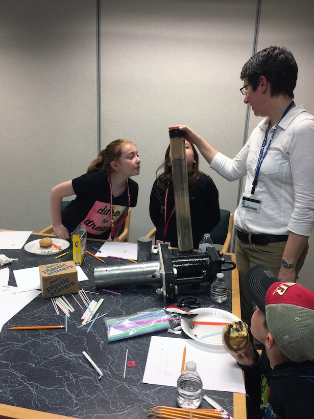 Marie Esten shows participants a core sample during the Underwater Sampling and Survey activity during Take Your Daughters and Sons to Work Day 2017.