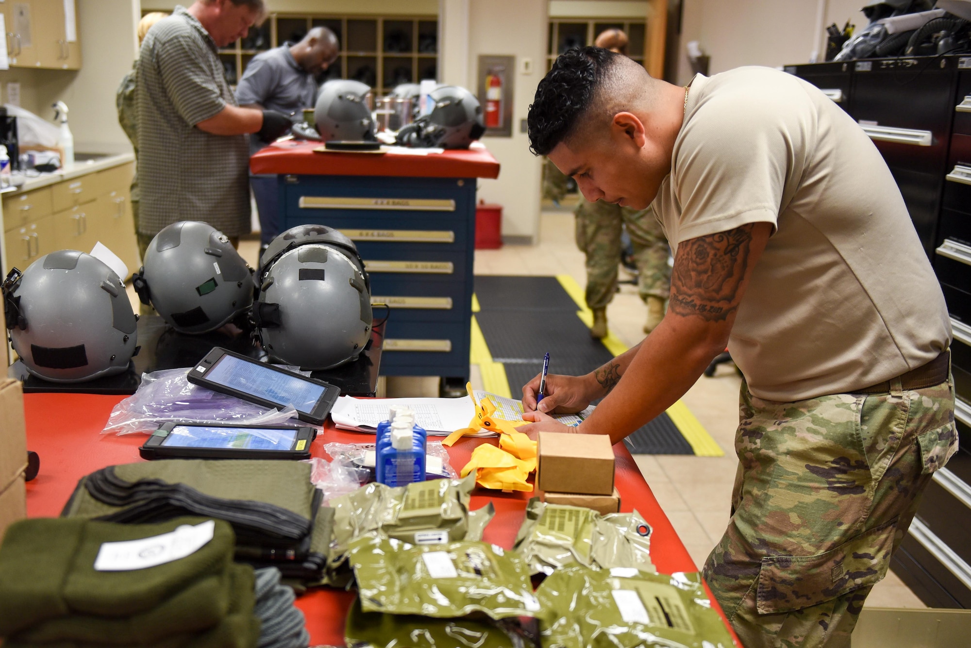 Tech. Sgt. Phillip Caicedo, an aircrew flight equipment technician with the 1st Special Operations Support squadron, packs an LRU-33A 20-man emergency life raft kit for an AC-130J Ghostrider at Hurlburt Field, Fla., June 15, 2017. Caicedo inspects the equipment required to complete the LRU-33A to ensure the equipment is not out of date and safe to use in the event of an in-flight emergency. (U.S. Air Force photo by Staff Sgt. Jeff Parkinson)