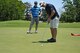 MXS’ Kyle Westerman attempts a par-3 putt on the eleventh hole as teammate Tyler Wilson watches quietly from behind at the Tinker Golf Course, May 31. (Air Force photo by Airman 1st Class Elliott Scott)