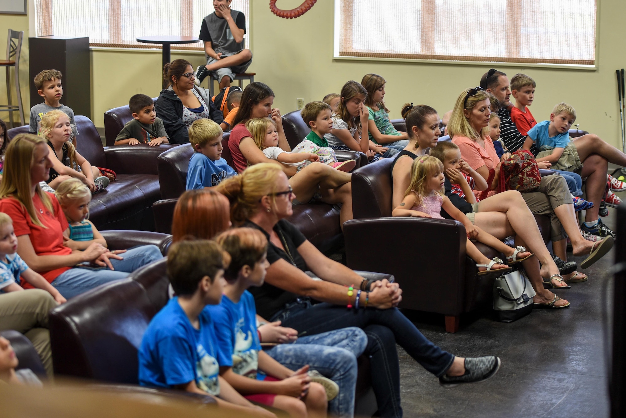 Children and their parents listen to a story during a Summer Reading Program event at Hurlburt Field, Fla., June 15, 2017. The program is hosted by the Hurlburt Field Library during the summer months to keep Air Commandos engaged in reading throughout summer vacation. (U.S. Air Force photo by Staff Sgt. Jeff Parkinson)