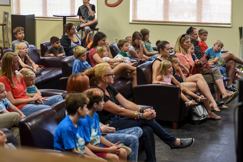 Children and their parents listen to a story during a Summer Reading Program event at Hurlburt Field, Fla., June 15, 2017. The program is hosted by the Hurlburt Field Library during the summer months to keep Air Commandos engaged in reading throughout summer vacation. (U.S. Air Force photo by Staff Sgt. Jeff Parkinson)