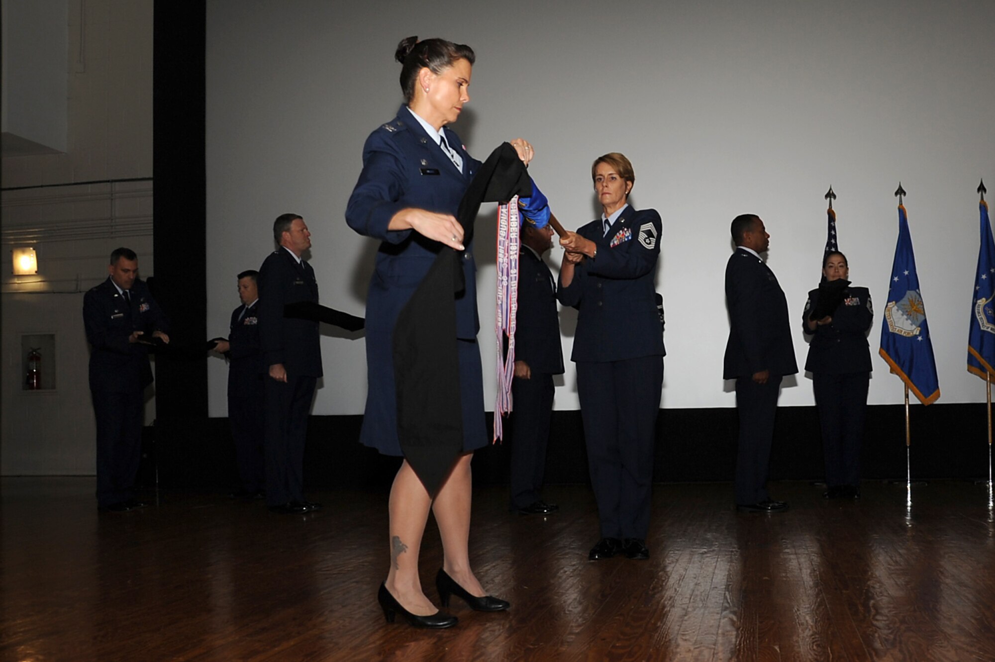 Col. Leslie Knight (foreground), 11th Medical Group commander, cases the guidon for the 779th Medical Group during an in-activation ceremony today at Joint Base Andrews, Md. The ceremony marked the in-activation of the 79th Medical Wing and celebrated the activation of the new 11th Medical Group. (Photo by Staff Sgt. Joe Yanik)