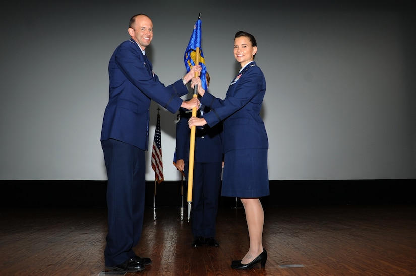 Col. E. John Teichert (left), 11th Wing commander, passes the 11th Medical Group guidon to Col. Leslie Knight, 11the MDG commander, during an inactivation ceremony June 16, 2017 at Joint Base Andrews, Md. The ceremony, presided over by Maj. Gen. Darryl Burke, Air Force District of Washington commander, marked the in-activation of the 79th Medical Wing and the activation of the 11th Medical Group.(Photo by Staff Sgt. Joe Yanik)