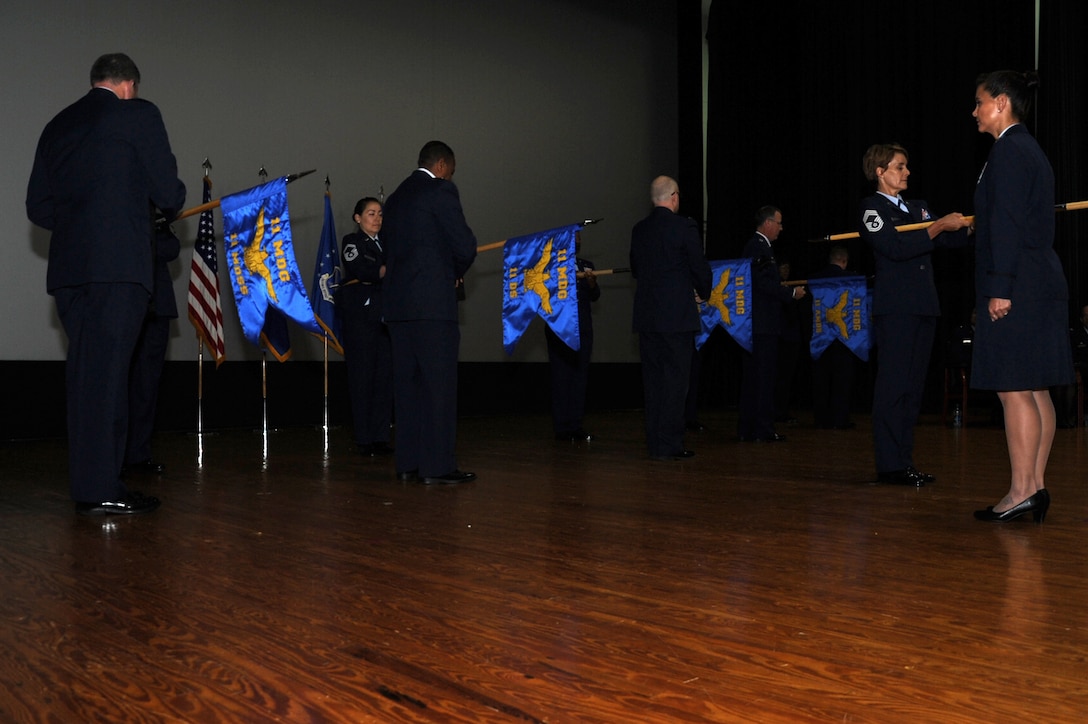 Senior group and squadron leaders unfurl guidons of the new 11th Medical Group during an activation ceremony June 16, 2017 at Joint Base Andrews, Md. The ceremony marks the transition of hundreds of the Capital Medics from the 779th MDG to the 11th MDG. (Photo by Staff Sgt. Joe Yanik)