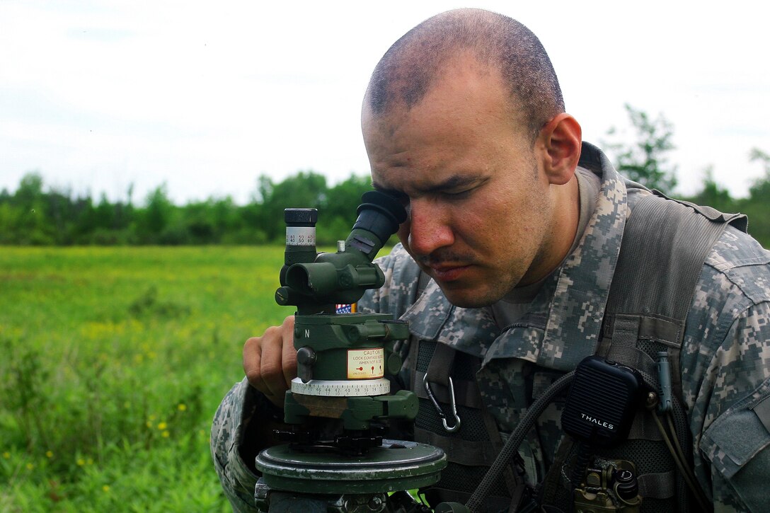 Army Staff Sgt. Nicholas Couvertier uses an azimuth measurement device to place an M119A2 105mm howitzer during an air assault artillery raid at Fort Drum, N.Y., June 9, 2017. Couvertier is a cannon crewmember assigned to Alpha Battery, 1st Battalion, 258th Artillery Regiment, 27th Infantry Brigade Combat Team of the New York Army National Guard. Army photo by Sgt. Alexander Rector