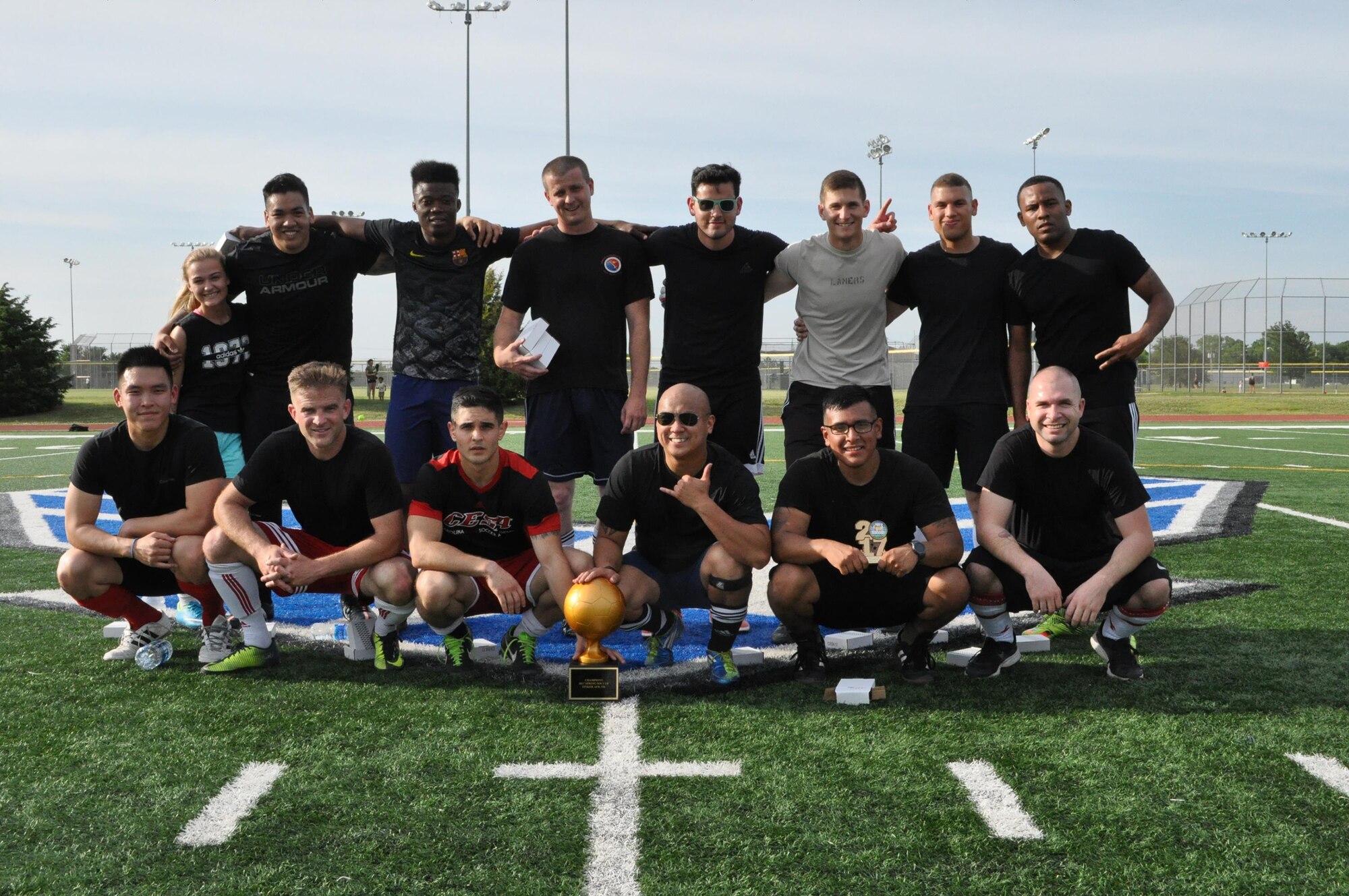 The MOF Hooligans gather around the spring 2017 intramural soccer championship trophy May 31 after defeating Security Forces 3-0. The team also won last season’s tournament in fall 2016. Names have been withheld in accordance with an Air Combat Command directive for the personal safety of its Airmen. (Air Force photo by John Parker)