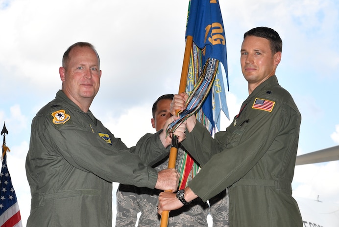 Col. Louis Hansen, 437th Operations Group commander passes  guideon to Lt. Col. Garrett Fisher, 15th Airlift Squadron incoming commander, during a change of command ceremony at Joint Base Charleston, South Carolina, June 15, 2017. The squadron bid farewell to the outgoing commander Lt. Col. Eric Bucheit and welcomed Fisher as the new squadron commander.