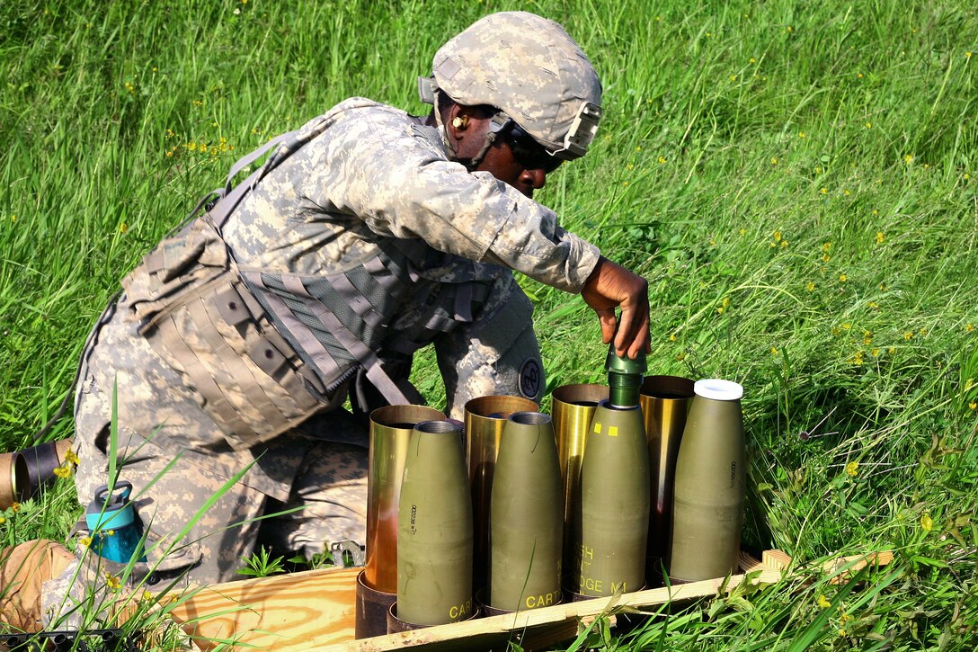 Army Spc. Matthews Ocansey prepares rounds to be fired from an M119A2 105mm howitzer during an air assault artillery raid at Fort Drum, N.Y., June 9, 2017. Natole is a cannon crewmember assigned to Alpha Battery, 1st Battalion, 258th Artillery Regiment, 27th Infantry Brigade Combat Team of the New York Army National Guard. Army  photo by Sgt. Alexander Rector