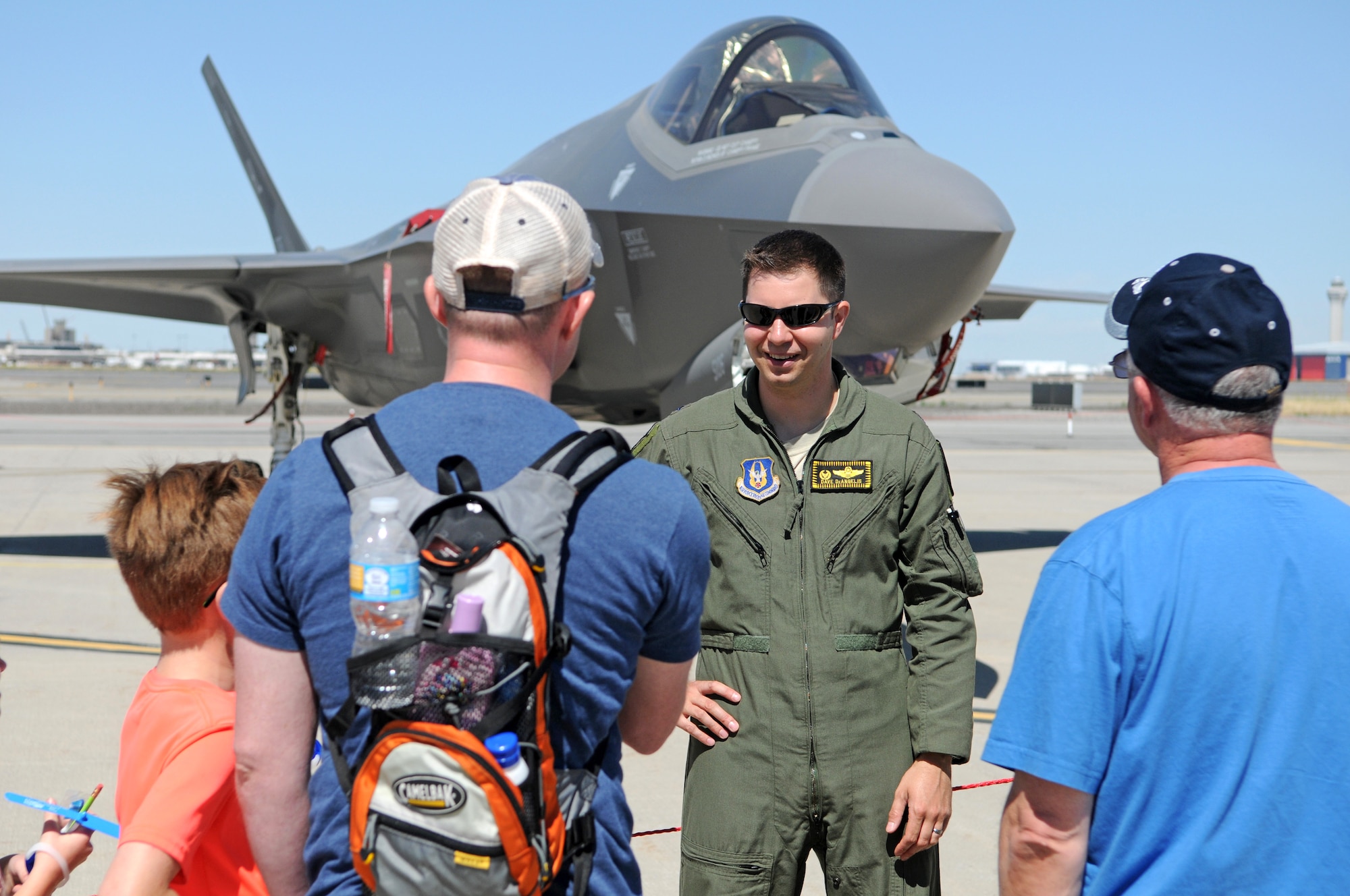 Lt. Col. David DeAngelis, a Reserve F-35 pilot from the 419th Fighter Wing at Hill Air Force Base, talks with Utah Air National Guard Airmen and their family members during Wingman Day on June 10, 2017 at Roland R. Wright Air National Guard Base. Hill AFB provided an F-35 Lightning II aircraft and an F-16 Fighting Falcon as static displays for the event, which drew more than 1,000 guests to the Guard base in Salt Lake City. (U.S. Air National Guard photo by Tech. Sgt. Amber Monio)