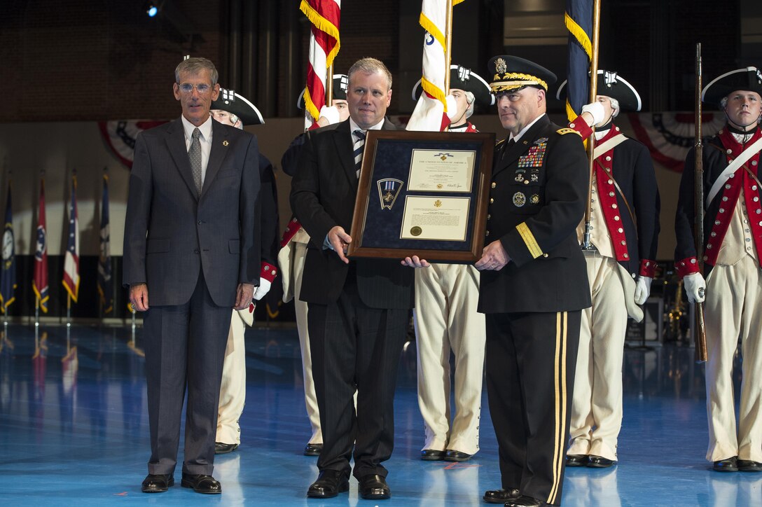 As part of a twilight tattoo event at Joint Base Myer-Henderson Hall, Va., held on honor of the Army's 242nd birthday, Acting Secretary of the Army Robert Speer, left, and Chief of Staff of the Army Gen. Mark A. Milley, right, present a posthumous Distinguished Flying Cross for Army Capt. James E. Miller to Miller's great-grandson, Byron Derringer, center, June 14, 2017. Army photo by Spc. Trevor Wiegel