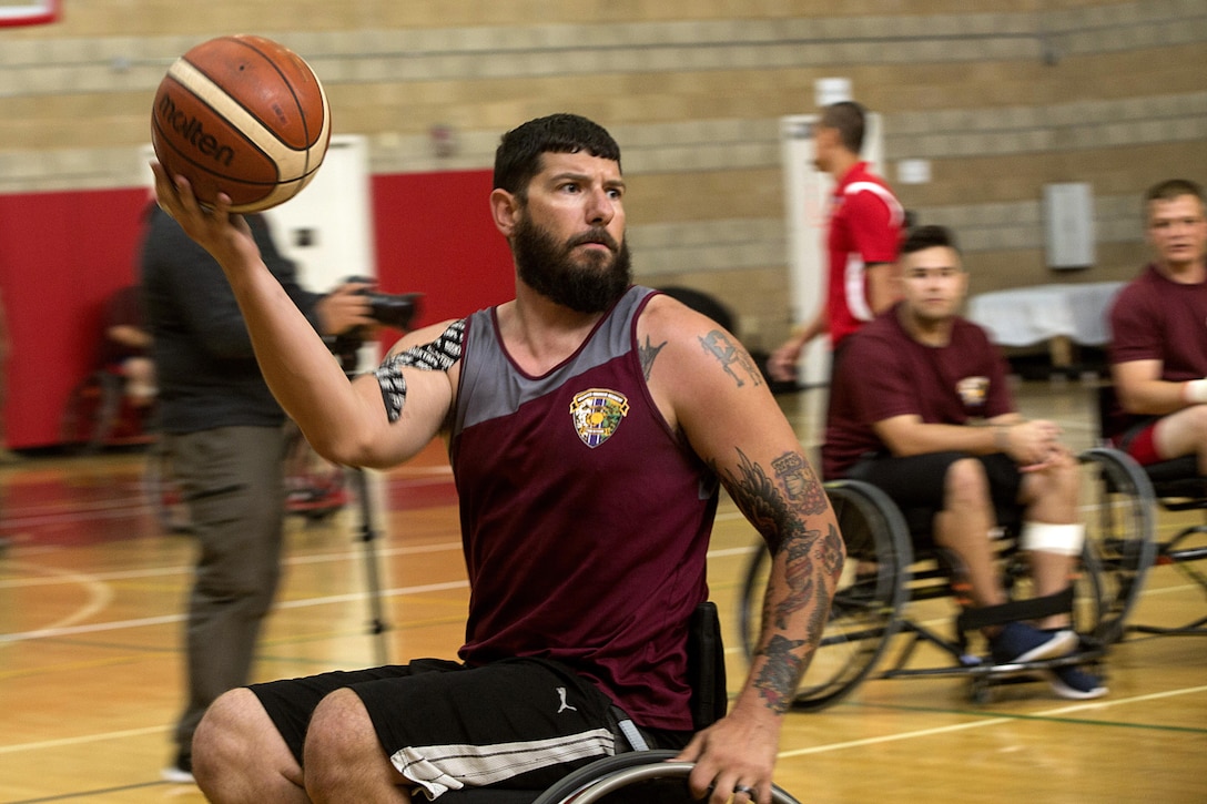 Marine Corps veteran Zack Guess passes the ball during the Marine Corps Trials' wheelchair basketball competition at Marine Corps Base Camp Pendleton, Calif., March 14, 2017. Marine Corps photo by Lance Cpl. Roderick Jacquote