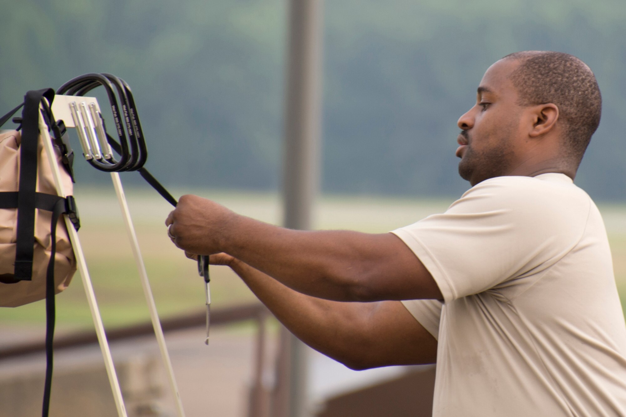 U.S. Air Force Reserve Staff Sgt. Michael Richardson, aircrew flight equipment technician, 913th Operations Support Squadron, attaches cutters to Station #6 of an Aircrew Contamination Control Area (ACCA) June 15, 2017, at Little Rock Air Force Base, Ark. Cutters are used at the ACCA remove laces and clothing during the decontamination process of aircrew members. (U.S. Air Force by Master Sgt. Jeff Walston/Released)