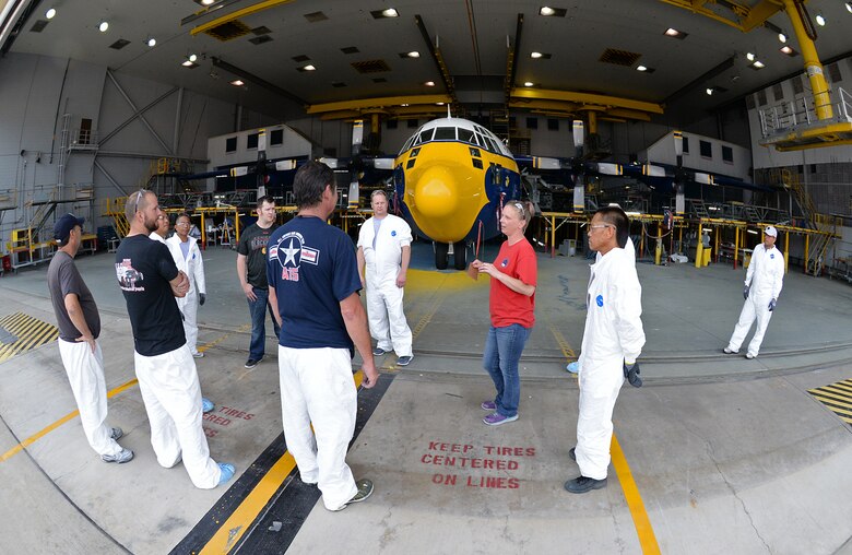 After all the hard work by both maintainers and painters, 576th Aircraft Maintenance Squadron wage leader Danielle Shaw (red shirt) assembles her crew for instructions before towing Fat Albert of the paint hangar on June 1 at Hill Air Force Base, Utah. The aircraft was towed to the 514th Flight Test Squadron for a shakedown flight to ensure all systems worked before being returned to the Blue Angels team. (U.S. Air Force Photo by Alex R. Lloyd)