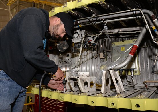 572nd Aircraft Maintenance Squadron production supervisor Jason Smith tightens the bolts on a C-130 Hercules’ lower wing rainbow fitting at Hill Air Force Base, Utah. The fittings are used to mate the center and outer wing sections on a C-130 and were the damaged parts first noticed under inspection on Fat Albert. (U.S. Air Force Photo by Alex R. Lloyd)