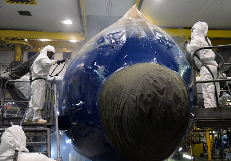 576th Aircraft Maintenance Squadron painters apply a second coat of blue paint on the fuselage of Fat Albert on May 17 at Hill Air Force Base, Utah. The aircraft received a new paint job following a major eight-month, depot-level maintenance overhaul. (U.S. Air Force Photo by Alex R. Lloyd)