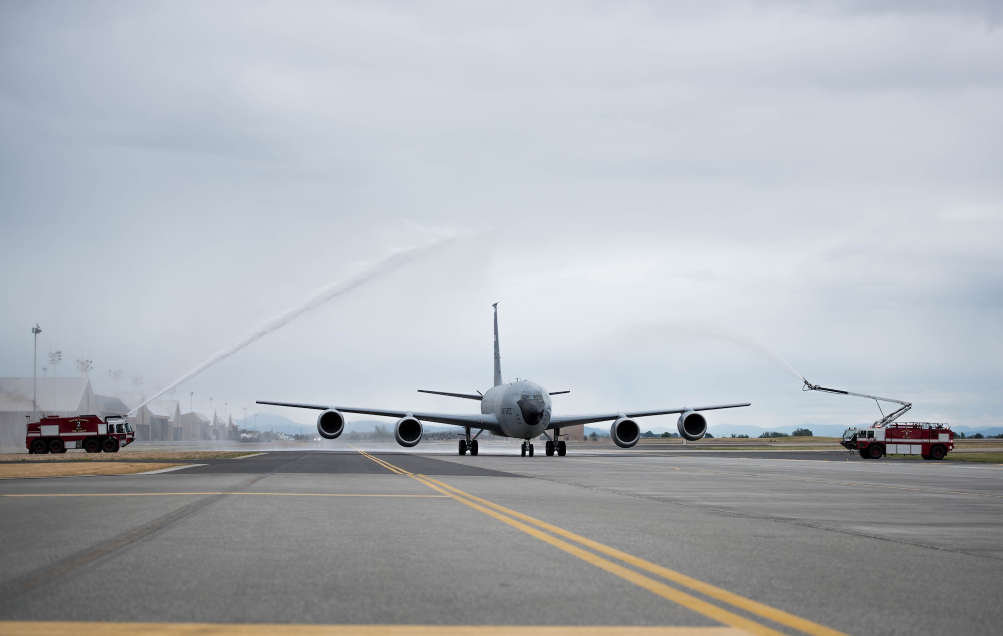 92nd Civil Engineer Squadron firefighters spray water over Col. Matthew Fritz’s KC-135 Stratotanker as he returns from his final flight June 15, 2017, at Fairchild Air Force Base, Washington. Fritz has been the 92nd Air Refueling Wing vice commander since June 2015. (U.S. Air Force photo/Senior Airman Sean Campbell)