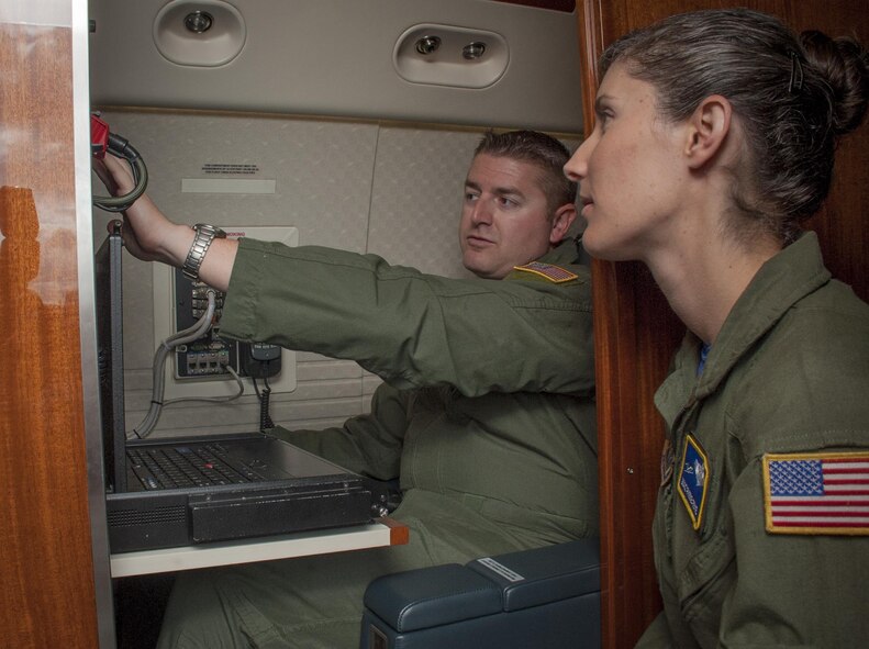 U.S. Air Force Tech. Sgt. Christopher Phillips, left, a communication systems operator (CSO) assigned to the 310th Airlift Squadron, runs through a pre-flight inspection with Master Sgt. Phebe Frye, the flight chief of CSOs assigned to the 310th AS, as he works to earn his instructor level certification at MacDill Air Force Base, Fla., May 5, 2017. In order to become an instructor, CSO must be certified on certain tasks by an evaluator. (U.S. Air Force photo by Airman 1st Class Mariette Adams)