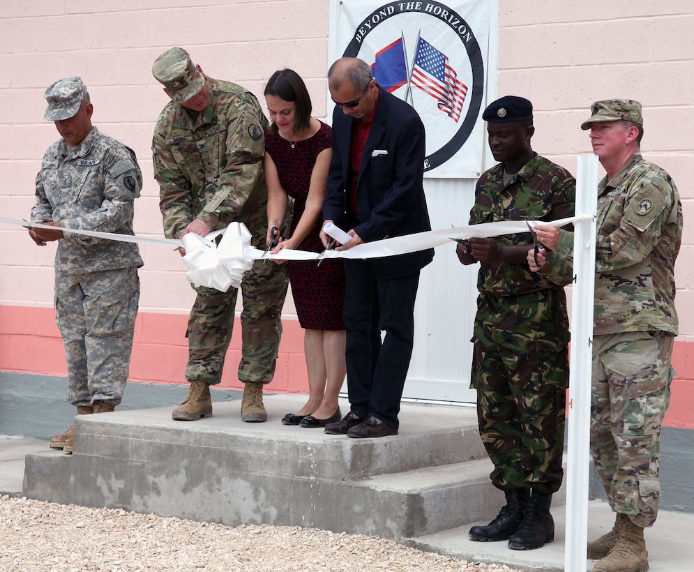 Completion of the new building at the Ladyville Health Clinic is officially marked at the ribbon-cutting ceremony June 9 in Ladyville, Belize. Shown cutting the ribbon (from left): Chief Warrant Officer 3 Herminio Romero, site project manager and member of the 448th Engineer Battalion from Puerto Rico; Col. John Simma, Beyond the Horizon 2017 Task Force Jaguar commander; Adrienne Galanek, Chargé d’Affaires for the U.S. Embassy Belize; Ramon Figueroa, CEO of the Belize Ministry of Health; Lance Cpl. Gladden of the Belize Defence Force and Lt. Col. Robert Ramsey, Senior Defense Official and Defense Attaché for the U.S. Embassy. Construction was accomplished during Beyond the Horizon 2017, a collaborative training event between U.S. Army South, the Belize Defence Force, other Central American nations and local and international NGOs, providing medical and engineering services throughout Belize. 