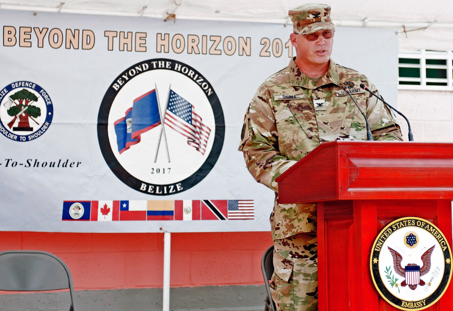 Col. John Simma, Commander for Beyond the Horizon 2017  Task Force Jaguar, speaks a the Ladyville Health Center Ribbon Cutting Ceremony June 9. BTH is a collaborative training event between U.S. Army South, the Belize Defence Force, other Central American nations and local and international NGO's providing medical and engineering services throughout Belize. Simma said the engineering projects and health events conducted during BTH uncluded approximately 1,900 U.S. Military members from the Army, Air Force, Marine Reserves and National Guard who worked shoulder-to-shoulder with members of the BDF, an Engineer Regiment from Trinidad and Tobago, and soldiers from the Columbian military.