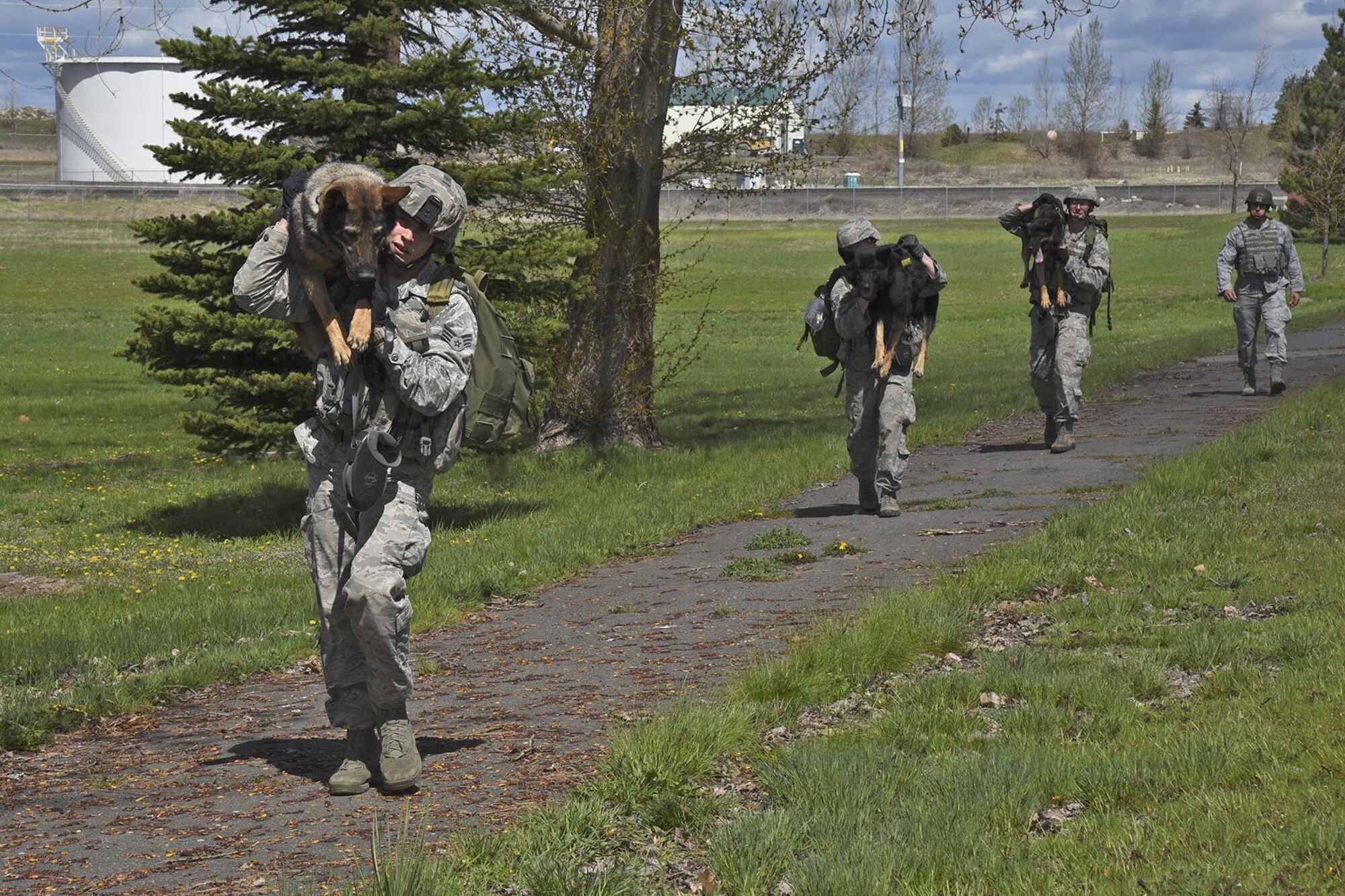 The 92nd Security Forces Squadron Military Working Dog section prepares for deployment with mental and physical exercises such as ruck marches. When deployed, the handler is not only carrying more than 50 pounds of their own equipment, they are carrying their K-9’s equipment and at times, their K-9. A dog’s stamina will be tested when for hours on end, they sweep for explosives in 100 degree weather. (U.S. Air Force photo/Senior Airman Mackenzie Richardson)