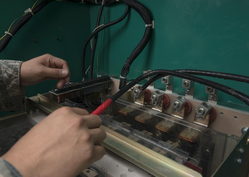 U.S. Air Force Senior Airman Jesus H. Hernandez, 7th Civil Engineer Squadron Electrical Power Production journeyman, reinstalls new wiring to a diesel-powered generator at Dyess Air Force Base, Texas, June 1, 2017. In addition to fixing issues, electrical Airmen also ensure electrical systems are running efficiently by scheduling tests on equipment quarterly. (U.S. Air Force photo by Airman 1st Class Katherine Miller)