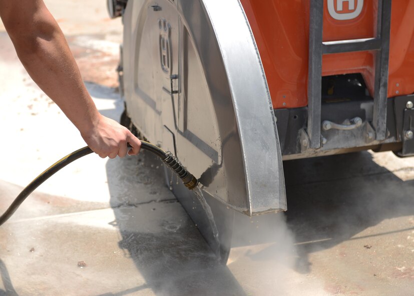 U.S Air Force Senior Airman Gary Witherow, 7th Civil Engineer Squadron pavements and heavy equipment operator journeymen, assists in cutting pavement to gain access to a damaged water pipe at Dyess Air Force Base, Texas, June 6, 2017. Pavement and heavy equipment operator Airmen use a variety of equipment and tools to repair and maintain Dyess’ roads, drainage systems and fencing. (U.S. Air Force photo by Airman 1st Class Katherine Miller)