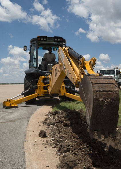 U.S Air Force Senior Airman Avery Shaw, 7th Civil Engineer Squadron pavements and heavy equipment operator journeyman operates a backhoe to dig a trench for a pipe at Dyess Air Force Base, Texas, June 6, 2017. The “Dirt Boyz” are on-call 24/7, 365 days a year in the event an emergency repair is needed on any of Dyess’ roads, drainage systems or fencing. (U.S. Air Force photo by Airman 1st Class Katherine Miller)