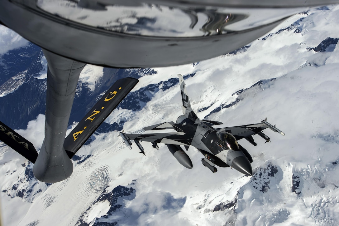 An Air Force F-16 flies near a KC-135 Stratotanker during refueling operations over Alaska, June 14, 2017, as part of exercise Red Flag-Alaska 17-2. The exercise focuses on improving ground, space and cyberspace combat readiness and interoperability for U.S. and international forces. Air Force photo by Staff Sgt. Paul Labbe