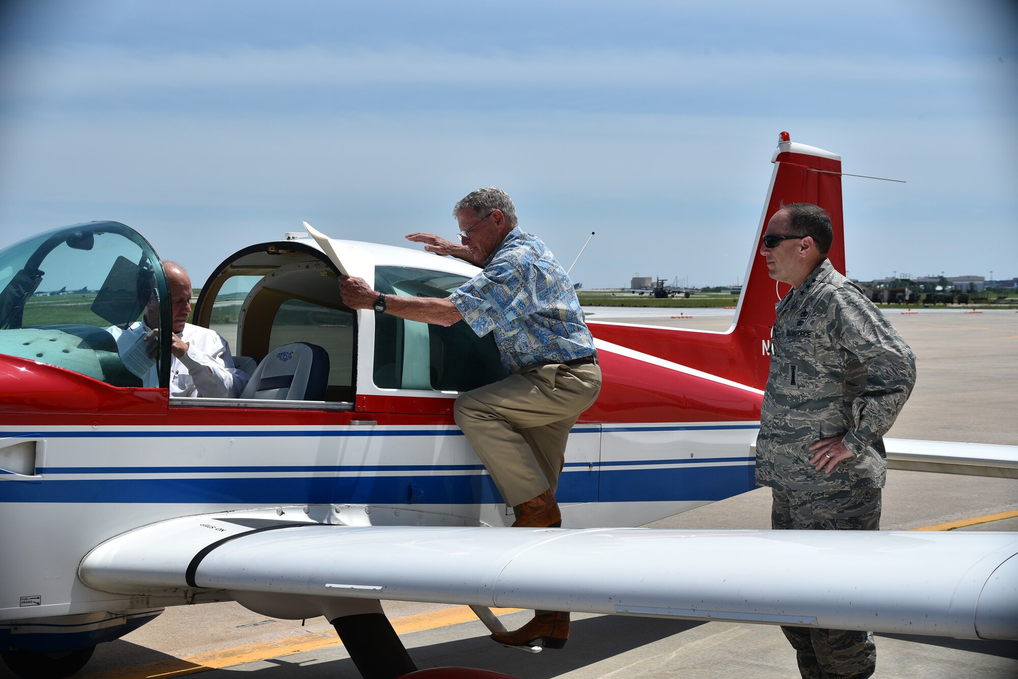 Lt. Gen. Lee K. Levy II, Air Force Sustainment Center commander, right, looks on as Sen. Jim Inhofe boards his airplane positioned in front of Base Ops following a brief visit to Tinker Air Force Base May 31. The senator was in the local area to attend a number of community events and received a quick tour of the base to discuss ongoing initiatives he’s working on Capitol Hill. The Oklahoma senator and pilot occasionally flies his own plane, a Grumman Tiger, when conducting business at Tinker. (Air Force photo by Darren D. Heusel)
