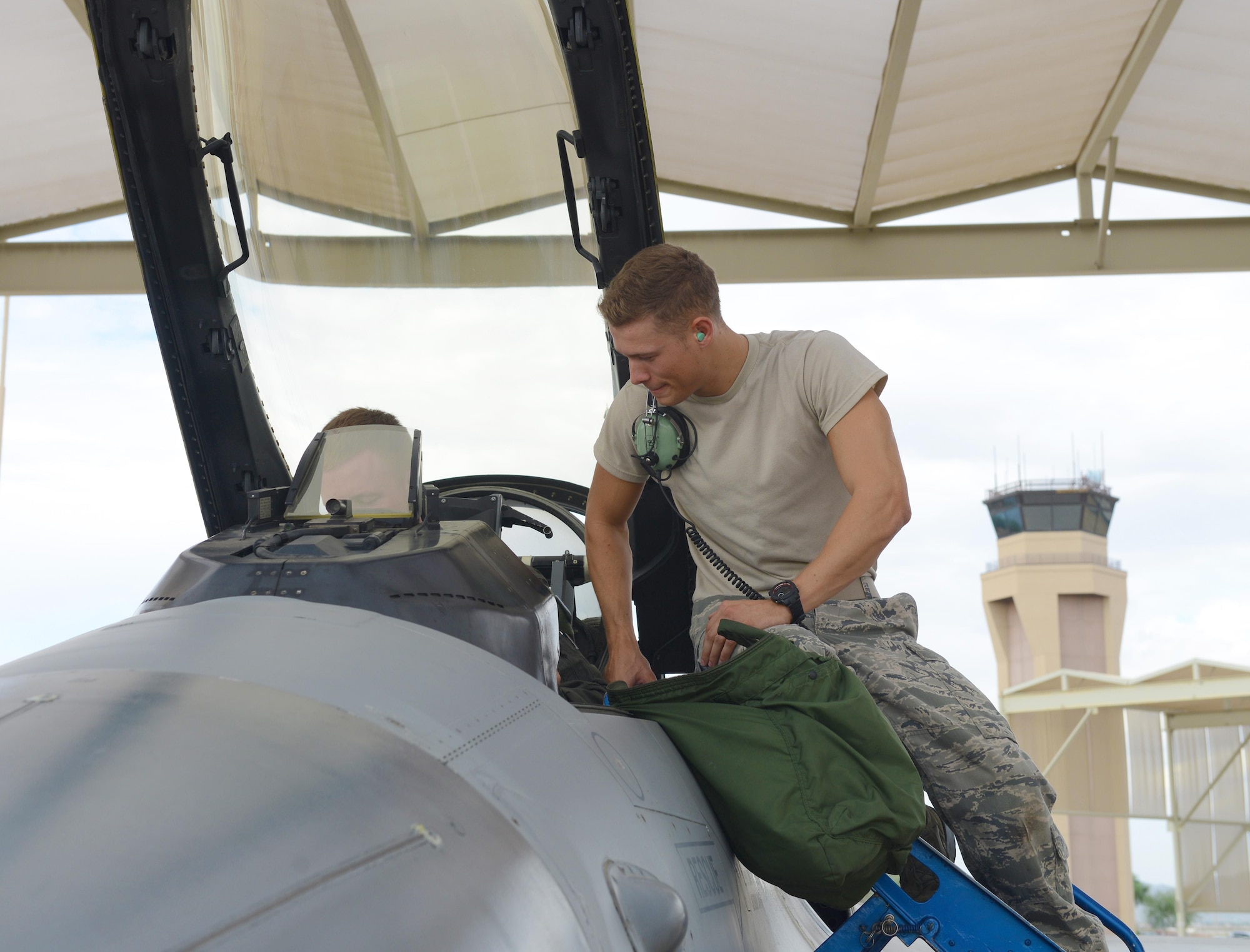 Airmen in the 309th Aircraft Maintenance Unit utilize sunshades to stay cool during the summer heat at Luke Air Force Base, Ariz. With temperatures exceeding 100 degrees, the shades keep both the Airmen who maintain the aircraft and the jets themselves cooler. (U.S. Air Force photo by Senior Airman James Hensley)