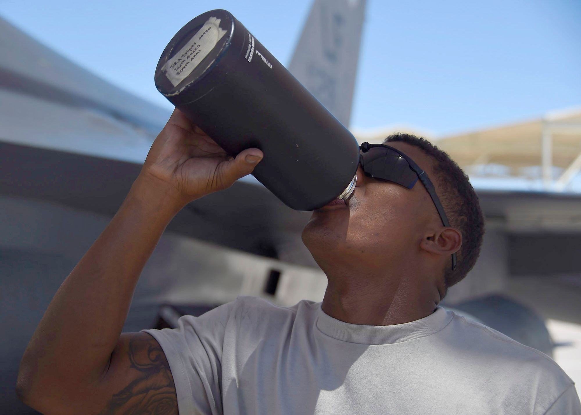 Senior Airman Lakenzar Snipes, 309th Aircraft Maintenance Unit crew chief, drinks water June 15, 2017, at Luke Air Force Base, Ariz. Staying hydrated is essential for maintainers especially during the summer months with tempertures exceeding 100 degrees. (U.S. Air Force photo by Senior Airman James Hensley)