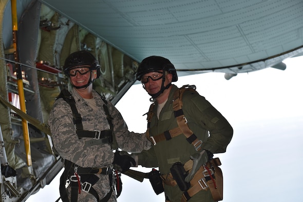 The 45th Space Wing Commander Brig. Gen. Wayne R. Monteith (left) and 920th Rescue Wing Commander Colonel Kurt A. Matthews, shake hands prior to tandem skydiving June 8, 2017, over Cape Canaveral Air Force Station, to demonstrate their wing's commitment to mutual-support and shared resources in an unforgettable way after signing a new host-tenant support agreement. (U.S. Air Force photo / Matthew Jurgens) 