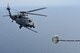 Airmen from the 920th Rescue Wing, Patrick Air Force Base, Florida, pilot an HH-60G Pave Hawk during an air-to-air refuel with a 920th HC-130P/N fixed-wing aircraft prior to a tandem jump by leaders from the HC-130 at both the both the 45th Space Wing and the 920th RQW, co-located at PAFB, to demonstrate their commitment to mutual-support and shared resources in an unforgettable way. (U.S. Air Force photo / Senior Airman Brandon Kalloo Sanes)