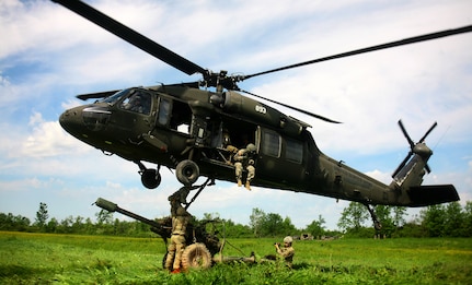 New York Army National Guard Soldiers assigned to Alpha Battery, 1st Battalion, 258th Field Artillery regiment, 27th Infantry Brigade Combat Team, prepare to attach a 105mm M119A2 Howitzer to UH-60 Black Hawk helicopter during an air assault artillery raid,at Fort Drum on June 9, 2017. 