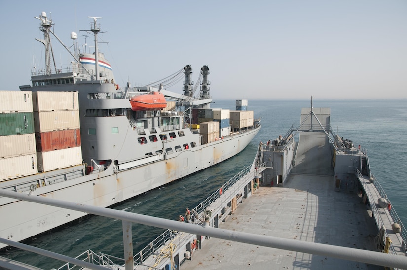 The crews of U.S. Army Watercraft Logistics Support Vessel 5 (LSV-5), “Maj. Gen. Charles P. Gross,” and Military Sealift Command Vessel Gem State prepare to secure their vessels to one another in the Persian Gulf, on June 13, 2017. The vessels participated in an in-stream cargo transfer exercise, moving containers from one boat to the other using the Gem State’s crane, in order to demonstrate the LSV’s sustainment support capabilities.  (U.S. Army photo by Sgt. Jeremy Bratt)
