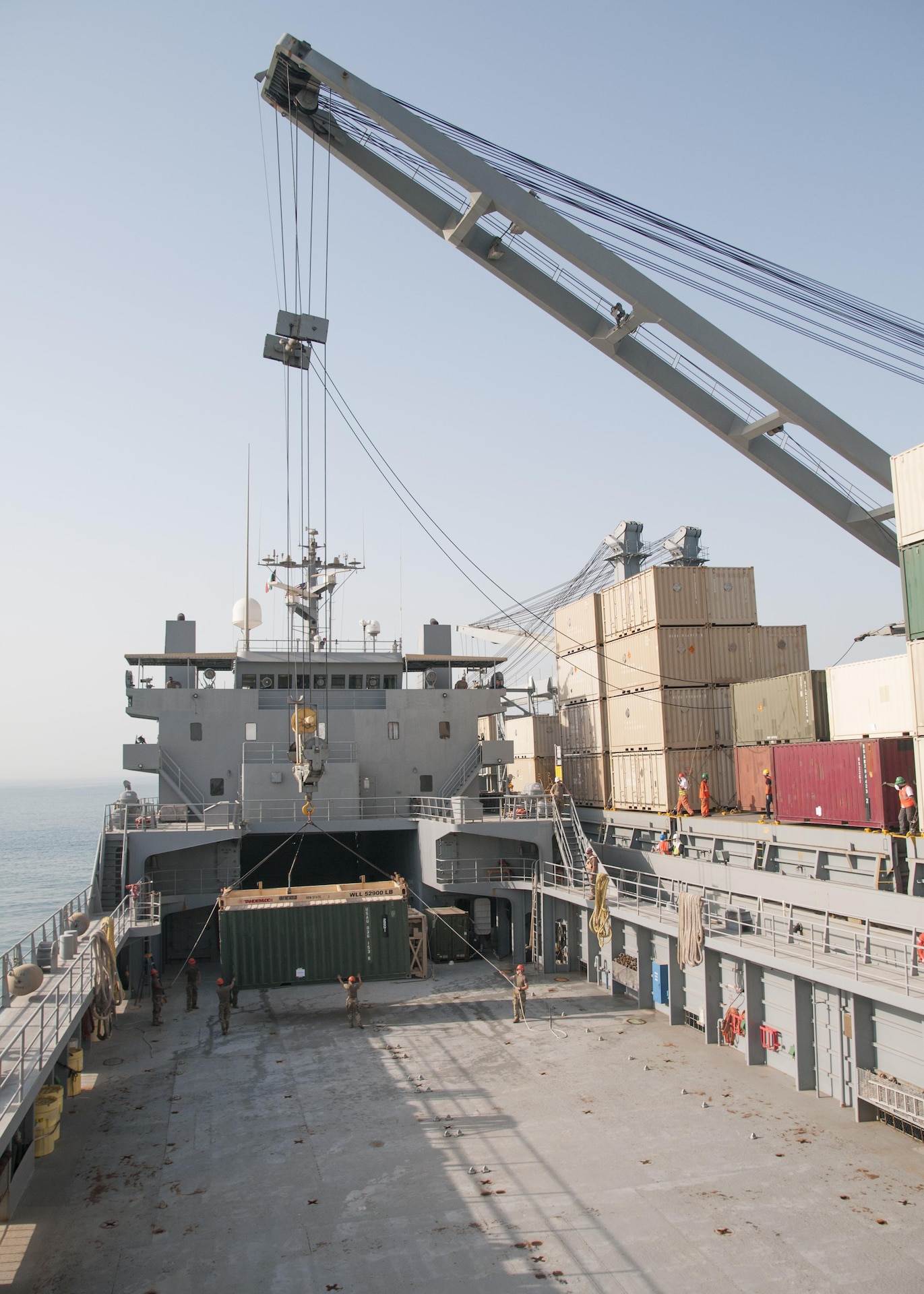 The crew of U.S. Army Watercraft Logistics Support Vessel 5 (LSV-5), “Maj. Gen. Charles P. Gross,” guides a container being lowered onto their deck by Military Sealift Command Vessel Gem State during an in-stream cargo transfer exercise in the Persian Gulf, on June 13, 2017. The vessels moved containers from one boat to the other using the Gem State’s crane, in order to demonstrate the LSV’s sustainment support capabilities.  (U.S. Army photo by Sgt. Jeremy Bratt)