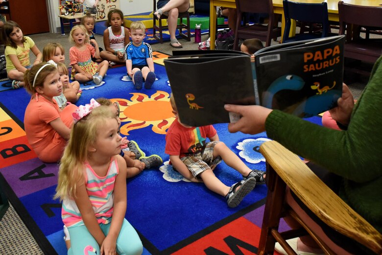 Alvina Smith, 4th Force Support Squadron library technician, reads to a group of children during weekly story time, June 13, 2017, at the base library at Seymour Johnson Air Force Base, North Carolina. The six-week Summer Reading Program includes weekly get-togethers for children ages newborn to teens. (U.S. Air Force photo by Airman 1st Class Victoria Boyton)