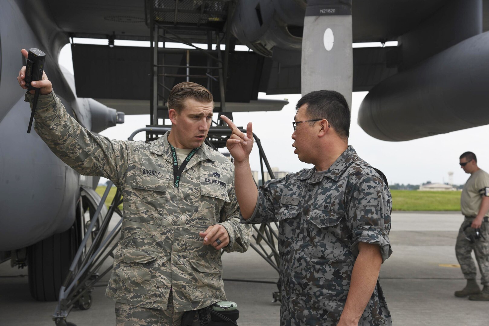 Japan Air Self-Defense Force Staff Sgt. Tatsuya Suzuki, 1st Techinical School Maintenance Section aircraft engine maintenance, asks a question about C-130 Hercules engine troubleshooting procesures to U.S. Air Force Tech. Sgt. Daylon Siverly, 374th Maintenance Squadron dock coordinator, during the Bilateral Exchange Program at Yokota Air Base, Japan, June 7, 2017. The program allowed American and Japanese Forces the opportunity to work together and learn from each other's daily operations and build a stronger relationship. 