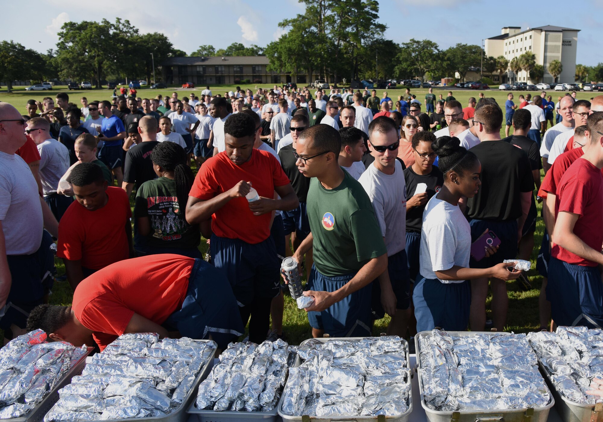 Keesler personnel help themselves to breakfast burritos before beginning field day activities June 15, 2017, on Keesler Air Force Base, Miss. Field day was the final event of Wingman Week, which focused on the physical pillar of Comprehensive Airman Fitness, resiliency and teambuilding initiatives across the base. (U.S. Air Force photo by Kemberly Groue)