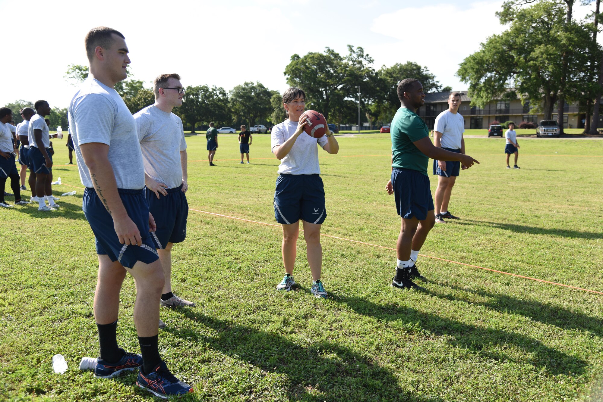 Col. Debra Lovette, 81st Training Wing commander, throws a football with Airmen from the 81st Medical Operations Squadron during field day events June 15, 2017, on Keesler Air Force Base, Miss. Field day was the final event of Wingman Week, which focused on the physical pillar of Comprehensive Airman Fitness, resiliency and teambuilding initiatives across the base. (U.S. Air Force photo by Kemberly Groue)