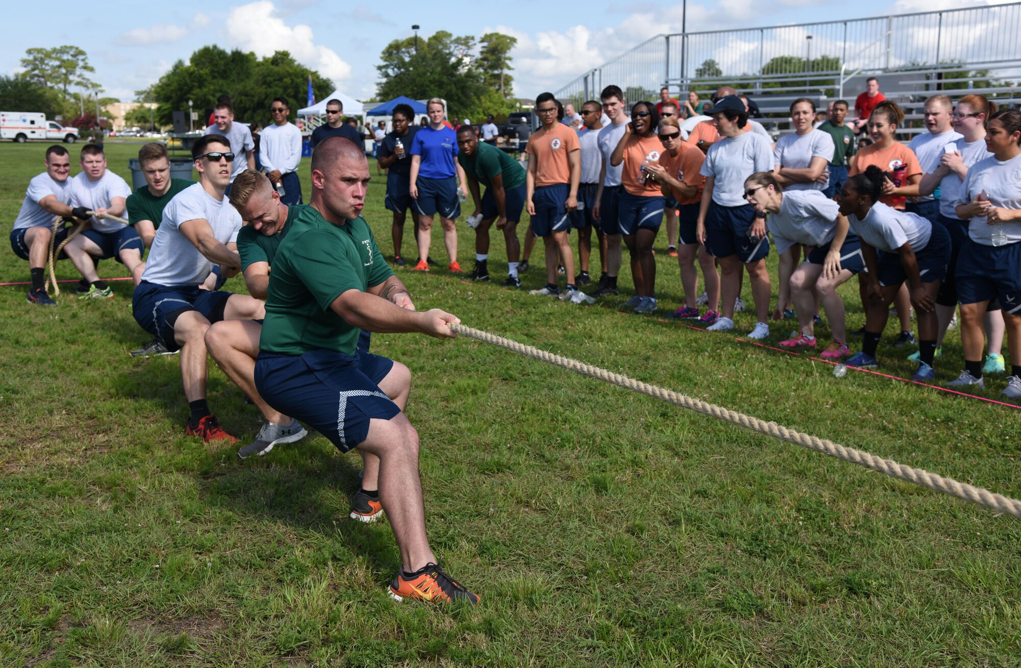 Tech. Sgt. Jeffrey Winter, 81st Medical Operations Squadron medical specialties NCO in charge, leads his team in a tug-of-war competition during field day June 15, 2017, on Keesler Air Force Base, Miss. Field day was the final event of Wingman Week, which focused on the physical pillar of Comprehensive Airman Fitness, resiliency and teambuilding initiatives across the base. (U.S. Air Force photo by Kemberly Groue)