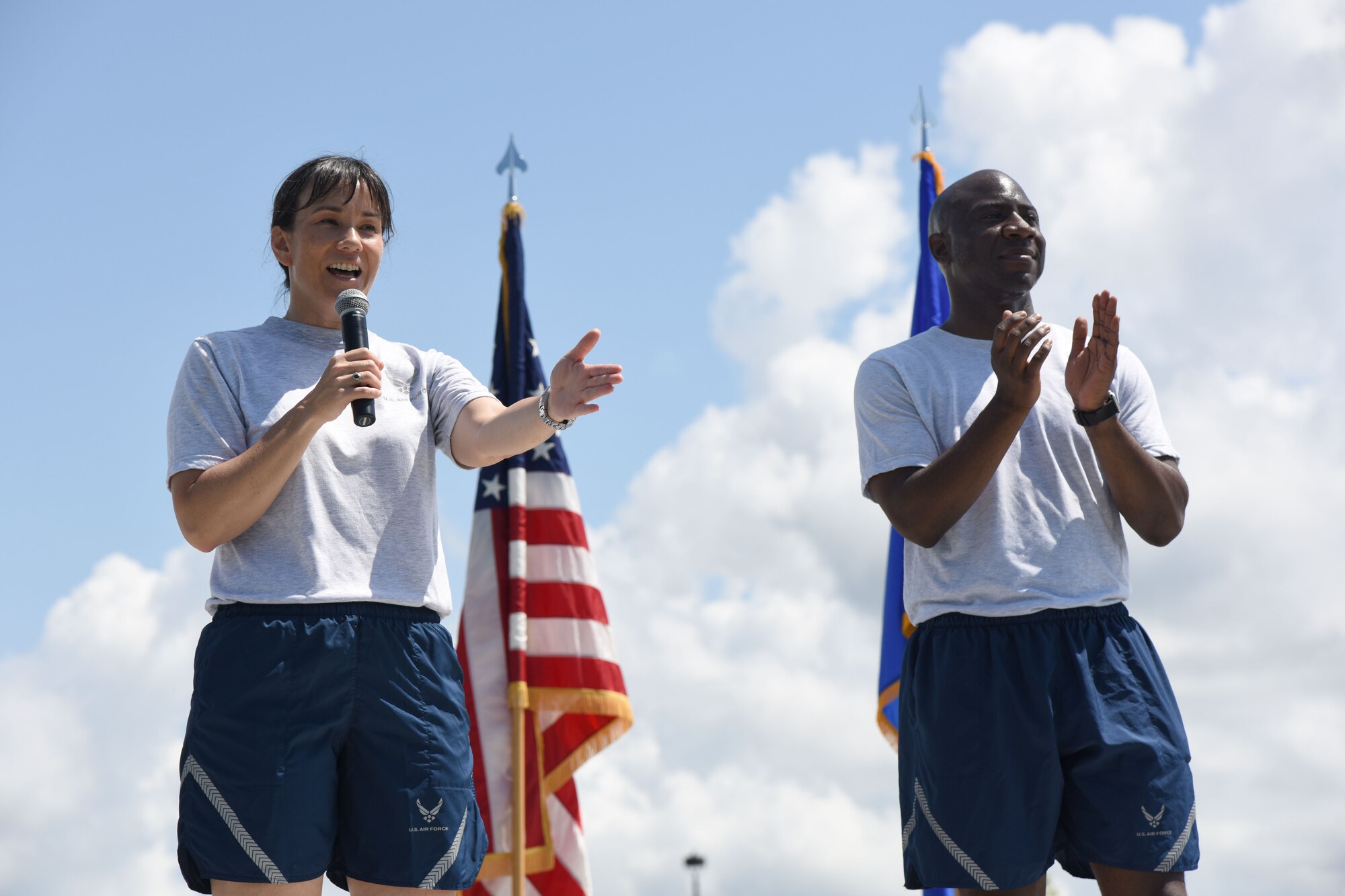 Col. Debra Lovette, 81st Training Wing commander, delivers remarks as Chief Master Sgt. Vegas Clark, 81st TRW command chief, stands by during field day June 15, 2017, on Keesler Air Force Base, Miss. Field day was the final event of Wingman Week, which focused on the physical pillar of Comprehensive Airman Fitness, resiliency and teambuilding initiatives across the base. (U.S. Air Force photo by Kemberly Groue)