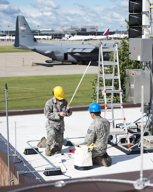U.S. Air Force Airmen from the 210th Engineering Installation Squadron add an antenna to a newly installed Giant Voice stack located on the roof of the Small Air Terminal at the 133rd Airlift Wing in St. Paul, Minn., June 19, 2017. Once complete, the system will provide improved emergency notification capabilities to flight line and maintenance personnel while aircraft engines are running. Strobes will also light up on top of the stack as an added visual durning alerts.   
(U.S. Air National Guard photo by Tech. Sgt. Austen R. Adriaens/Released)