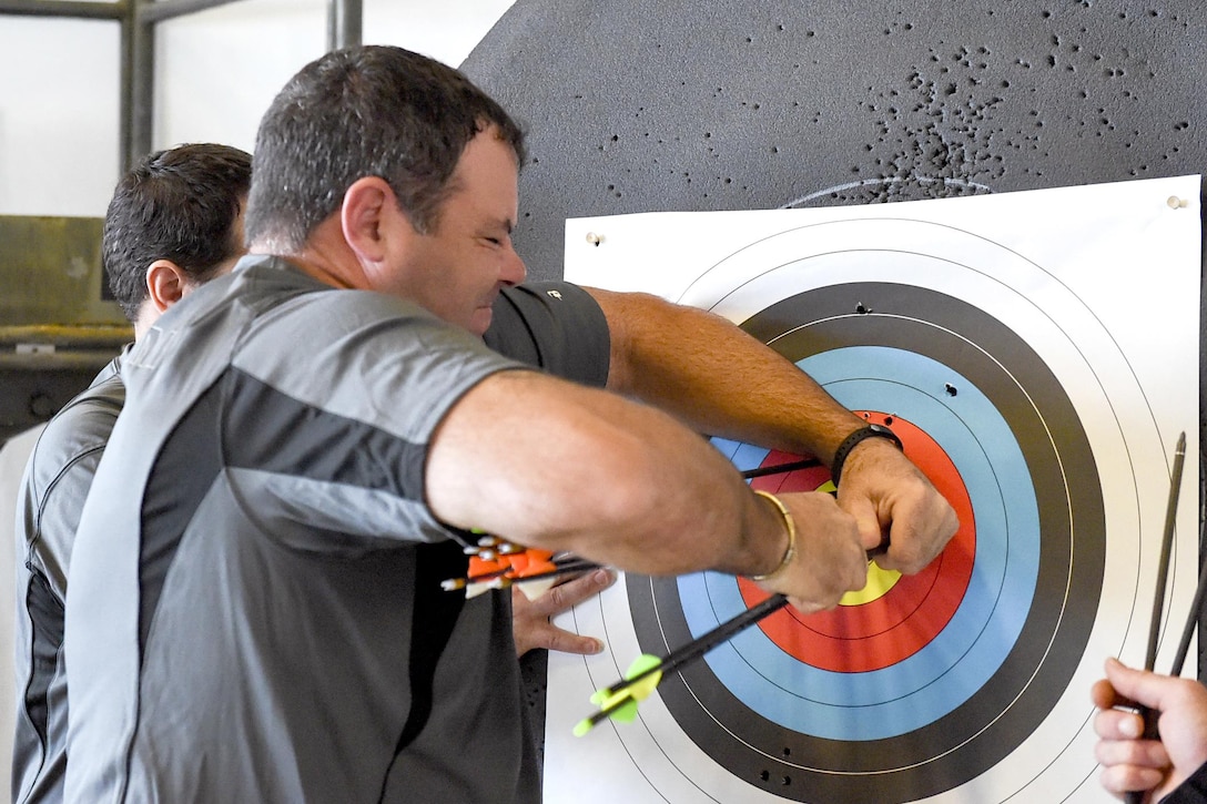 Athletes from U.S. Special Operation Command’s military adaptive sports program remove arrows from a target during the bow competition at Socom’s 2017 Department of Defense Warrior Games tryouts held at MacDill Air Force Base, Fla., Feb. 27, 2017. Navy photo by Petty Officer 2nd Class J. Michael Schwartz